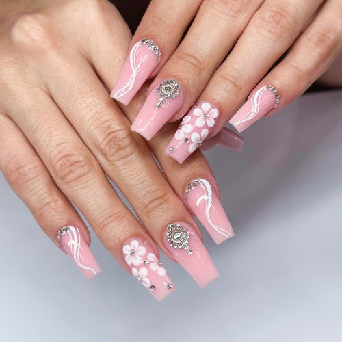 Woman with almond long pink nails design. Manicure. Nail salon. Classic bridal nail design. Summer nails